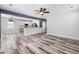 This open living room features lots of windows, neutral colors, and lovely wood-look floors at 1070 Moss Grove Dr, Moncks Corner, SC 29461