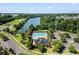 Aerial image of a community pool and clubhouse by a lake with mature trees and playground in the background at 1070 Moss Grove Dr, Moncks Corner, SC 29461