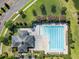 Aerial view of community pool with lounge chairs and clubhouse, all well landscaped with mature pink Crepe Myrtle trees at 1070 Moss Grove Dr, Moncks Corner, SC 29461