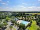 An aerial view of the community pool and clubhouse, surrounded by ample parking and bordered by green spaces at 1070 Moss Grove Dr, Moncks Corner, SC 29461