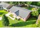 Aerial view of a brick home with a grey roof surrounded by a green lawn and mature trees at 109 Ashdown Dr, Summerville, SC 29483