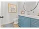 Bathroom boasts a blue vanity with a white countertop, decor, and a round mirror at 109 Ashdown Dr, Summerville, SC 29483