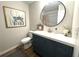 Bathroom with a blue vanity, white countertop, decor, and a round mirror adding charm at 109 Ashdown Dr, Summerville, SC 29483
