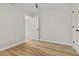 A bright empty bedroom boasts wood-look floors, a ceiling fan, and an entryway to another room at 109 Ashdown Dr, Summerville, SC 29483