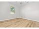 A bright empty bedroom boasts wood-look floors, a ceiling fan, and a window letting in lots of natural light at 109 Ashdown Dr, Summerville, SC 29483