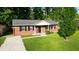 Charming single-story brick home featuring a well-manicured lawn and classic black shutters at 109 Ashdown Dr, Summerville, SC 29483
