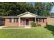 A single-story brick home with black shutters, a well-maintained lawn, and a welcoming front porch at 109 Ashdown Dr, Summerville, SC 29483