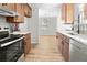 Open kitchen with stainless steel appliances, wood cabinets and white countertops which flows into dining area at 109 Ashdown Dr, Summerville, SC 29483