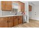 Well-lit kitchen featuring wood cabinets, stainless steel dishwasher, white countertop, and modern faucet at 109 Ashdown Dr, Summerville, SC 29483