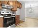 This kitchen features stainless steel appliances, wood cabinets, gray backsplash, and flows into the dining area at 109 Ashdown Dr, Summerville, SC 29483