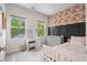 Bright bedroom with floral accent wall, white furniture, and natural light from the windows at 109 W Respite Ln, Summerville, SC 29483