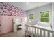 Stylish bedroom featuring pink accent wall, white furniture, and a well-lit vanity area at 109 W Respite Ln, Summerville, SC 29483