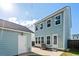 Exterior view of the home and detached garage with modern design and backyard patio at 109 W Respite Ln, Summerville, SC 29483