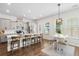 Modern kitchen featuring stainless steel appliances, center island with breakfast bar, and adjacent dining area at 109 W Respite Ln, Summerville, SC 29483