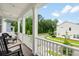 Relaxing front porch with rocking chairs offering a view of the neighborhood at 109 W Respite Ln, Summerville, SC 29483