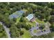Aerial view of a community pool, tennis courts, and parking area surrounded by lush trees at 109 Waveney Cir, Goose Creek, SC 29445