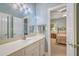 Bright bathroom vanity with a white countertop, featuring a large mirror and access to an adjacent bedroom at 109 Waveney Cir, Goose Creek, SC 29445