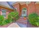 Beautiful brick home entrance featuring an arched doorway and elegant landscaping at 109 Waveney Cir, Goose Creek, SC 29445