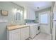 Bright laundry room with white cabinetry, countertop, sink, modern washer/dryer, and a door to the exterior at 109 Waveney Cir, Goose Creek, SC 29445