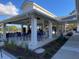Outdoor bar area with seating, adjacent to a golf course, featuring a covered structure and manicured landscaping at 109 Waveney Cir, Goose Creek, SC 29445