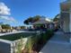 Outdoor seating area with tables and chairs, putting green, adjacent to a golf course, with manicured landscaping at 109 Waveney Cir, Goose Creek, SC 29445