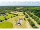 Overhead shot reveals property surrounded by greenery, other homes and a winding road at 1111 Sandy Springs Circle, Walterboro, SC 29488