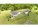A high-angle aerial showing the home with a back patio, a detached garage, and a fenced-in backyard at 1111 Sandy Springs Circle, Walterboro, SC 29488