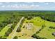 Aerial view displays the property's vast lot, featuring a home, landscaping, and an approximated boundary line at 1111 Sandy Springs Circle, Walterboro, SC 29488