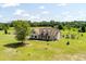 Aerial view of a charming home with a sprawling lawn, mature trees, and landscaped gardens at 1111 Sandy Springs Circle, Walterboro, SC 29488