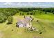 Aerial view featuring a home with a backyard patio, a detached garage, and a large fenced area at 1111 Sandy Springs Circle, Walterboro, SC 29488