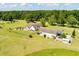 Aerial view of country estate featuring well-manicured lawn, fenced yard, and detached garage at 1111 Sandy Springs Circle, Walterboro, SC 29488
