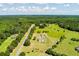 Aerial view highlights the location amid lush trees, a long road, and manicured lawns at 1111 Sandy Springs Circle, Walterboro, SC 29488