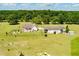 Aerial view of country estate featuring well-manicured lawn, fenced yard, and detached garage at 1111 Sandy Springs Circle, Walterboro, SC 29488