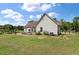 Backyard view featuring a patio, outdoor seating, landscaping, and expansive lawn at 1111 Sandy Springs Circle, Walterboro, SC 29488