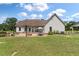 Backyard view featuring a patio, fire pit, seating, and well-maintained lawn at 1111 Sandy Springs Circle, Walterboro, SC 29488