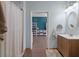 Bathroom leading to another room with a sink, an oval mirror, and neutral walls at 1111 Sandy Springs Circle, Walterboro, SC 29488