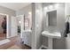 View from bathroom, showcasing a pedestal sink and an open door to the main bedroom at 1111 Sandy Springs Circle, Walterboro, SC 29488