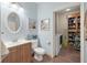 Bright bathroom with vanity, framed wall art, and access to a laundry area at 1111 Sandy Springs Circle, Walterboro, SC 29488