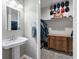 Bathroom featuring pedestal sink, and a walk-in closet showcasing hats and clothes at 1111 Sandy Springs Circle, Walterboro, SC 29488