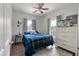 Bedroom with blue bedding, ceiling fan, and windows providing natural light at 1111 Sandy Springs Circle, Walterboro, SC 29488