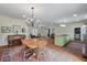 Spacious dining room open to the living room and kitchen, featuring a modern chandelier at 1111 Sandy Springs Circle, Walterboro, SC 29488