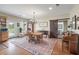 Inviting dining room with chandelier, hardwood floors, and sliding barn door to the bathroom at 1111 Sandy Springs Circle, Walterboro, SC 29488