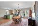 Open-concept dining area with modern chandelier and hardwood floors next to the kitchen at 1111 Sandy Springs Circle, Walterboro, SC 29488