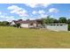 Backyard view with lush green grass, trees, and home with a covered back porch at 1111 Sandy Springs Circle, Walterboro, SC 29488