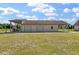 View of the garage with two bays and an attached covered area on a large lot with green grass at 1111 Sandy Springs Circle, Walterboro, SC 29488
