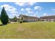 View of the detached garage with two bays and an attached covered area in a large grassy lot at 1111 Sandy Springs Circle, Walterboro, SC 29488