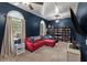 Comfortable living room with a red sofa, arched windows, and custom built-in bookcase at 1111 Sandy Springs Circle, Walterboro, SC 29488