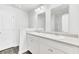 Bathroom with double sinks, large mirrors, and white cabinets at 113 Cozy Nest Way, Summerville, SC 29483