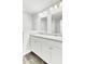 Bathroom with double sinks, large mirrors, and white cabinets at 113 Cozy Nest Way, Summerville, SC 29483