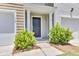 Inviting entryway with a covered porch, manicured bushes, and classic front door at 113 Cozy Nest Way, Summerville, SC 29483